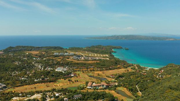 Tropical island Boracay with sandy beach and hotels view from the sea, aerial view. Summer and travel vacation concept. Philippines