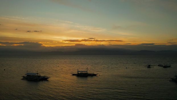 Colorful bright clouds during sunset over the sea, aerial view. Sunset over ocean. Seascape, Summer and travel vacation concept, Moalboal, Philippines.