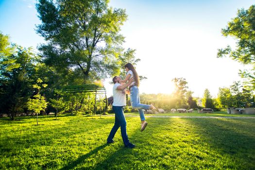 Young romantic couple have fun enjoy each other in green summer park.