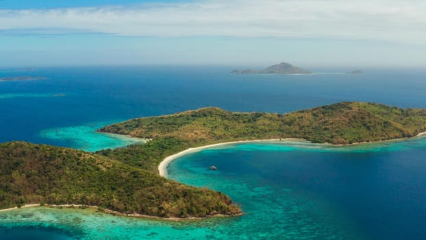 tropical island with blue lagoon, coral reef and sandy beach. Ditaytayan, Palawan, Philippines. Islands of the Malayan archipelago with turquoise lagoons.