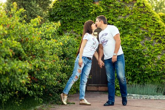 Young romantic couple have fun enjoy each other in green summer park.