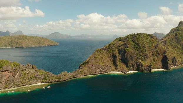 Bay and the tropical islands. Seascape with tropical rocky islands, ocean blue wate, aerial view. islands and mountains covered with tropical forest. El nido, Philippines, Palawan. Tropical Mountain Range