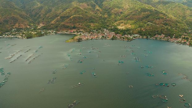 Aerial view of fish farm with cages for fish and shrimp on the lake Taal, Philippines, Luzon. Fish ponds for bangus, milkfish.