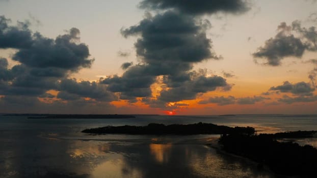 Colorful sunset over tropical islands, aerial view. Sunset over ocean. Balabac, Palawan, Philippines