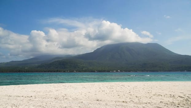 Seascape ocean,mountains and beautiful beach paradise. Beach, sea, sand,wave. Tropical beach, blue sky, clouds Philippines Camiguin Travel concept