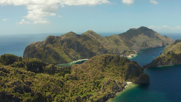 Seascape with tropical rocky islands, ocean blue water, aerial view . islands and mountains covered with tropical forest. El nido, Philippines, Palawan. Tropical Mountain Range
