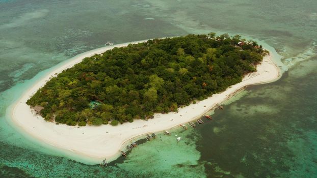 Tropical island and sandy beach surrounded by atoll and coral reef with turquoise water, aerial drone. Tropical island and coral reef. Summer and travel vacation concept, Camiguin, Philippines, Mindanao