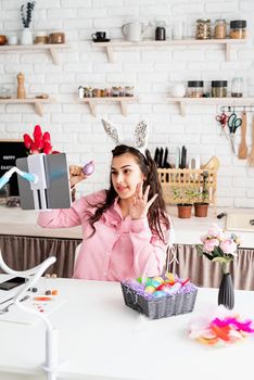 beautiful woman greeting her friends online, celebrating easter