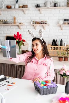 beautiful woman greeting her friends online, celebrating easter