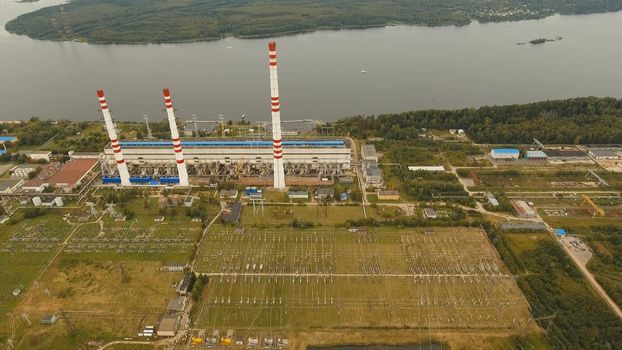 Aerial view Hydroelectric power station, transformation station, cables and wires. High voltage electric power substation. Electrical power transformer in high voltage substation.