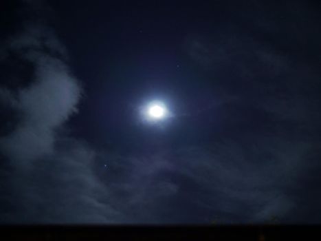 full moon clouds at night blue sky