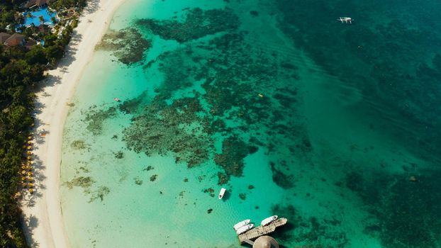 White sandy beach with tourists and hotels in Boracay Island, Philippines, aerial view. Seascape with beach on tropical island. Summer and travel vacation concept.