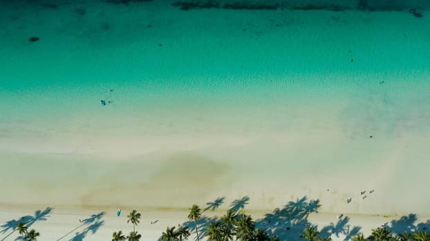 Tropical sandy beach with wave and turquoise water,copy space for text, aerial view. Ocean with waves and tropical beach. Summer and travel vacation concept