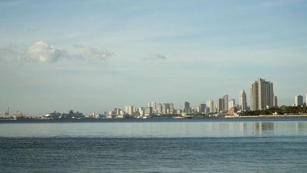 Manila city, skyscrapers and buildings. Seascape coastal city of Manila. Modern city by sea. Makati district. Travel concept.