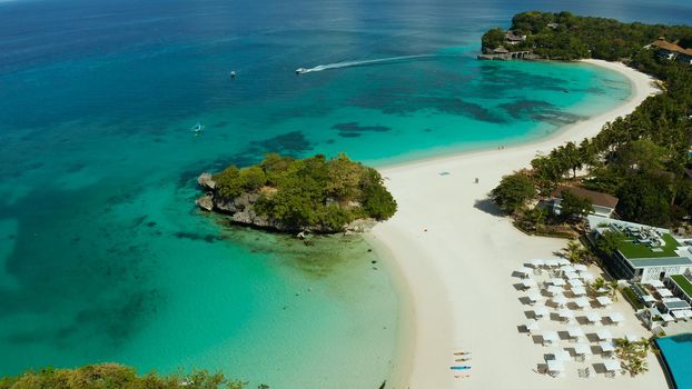 Travel concept: sandy beach and hotels near the blue lagoon, from above, Boracay, Philippines. Seascape with beach on tropical island. Summer and travel vacation concept.