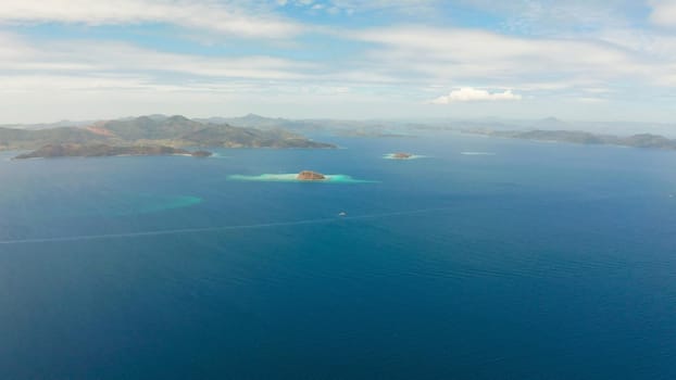 aerial seascape Lagoons with blue, azure water in middle of small islands. Palawan, Philippines. tropical islands with blue lagoons, coral reef. Islands of the Malayan archipelago with turquoise lagoons.