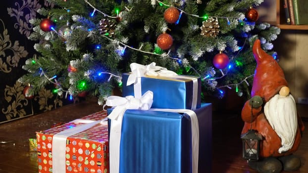 Decorated christmas tree with colorful balls and gifts. Christmas and New Year decorated interior room with presents and New year tree.
