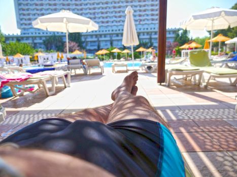 a man rests by the pool relax