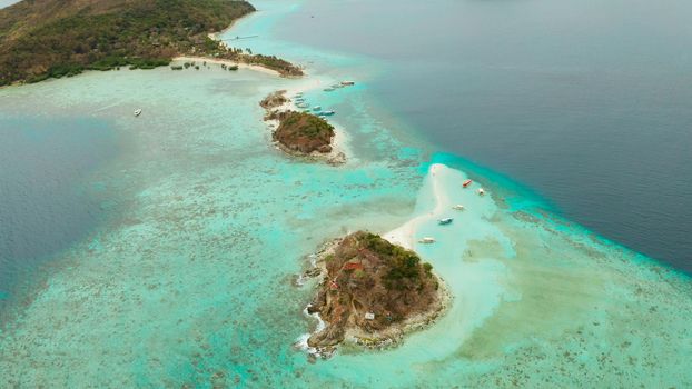 aerial view tropical island with sand white beach. Bulog Dos, Philippines, Palawan. Seascape bay with turquoise water and coral reef.