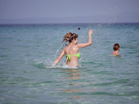 long woman play on the blue sea