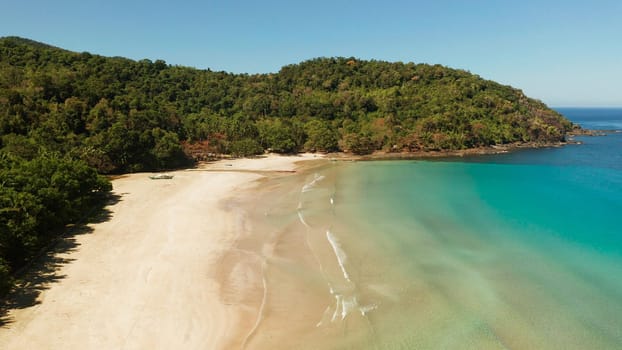 above view tropical sandy beach and blue water. Nagtabon. Palawan, Philippines. Seascape with sea, sand, palm trees. Summer and travel vacation concept