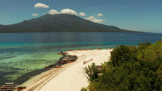 Tropical island with sandy beach with atoll and coral reef, aerial drone. Island on turquoise atoll. Summer and travel vacation concept, Camiguin, Philippines, Mindanao