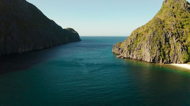 Seascape with tropical rocky islands, ocean blue water, aerial view . islands and mountains covered with tropical forest. El nido, Philippines, Palawan. Tropical Mountain Range