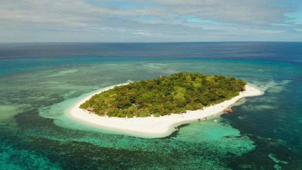 Tropical island and sandy beach surrounded by atoll and coral reef with turquoise water, aerial drone. Tropical island and coral reef. Summer and travel vacation concept, Camiguin, Philippines, Mindanao