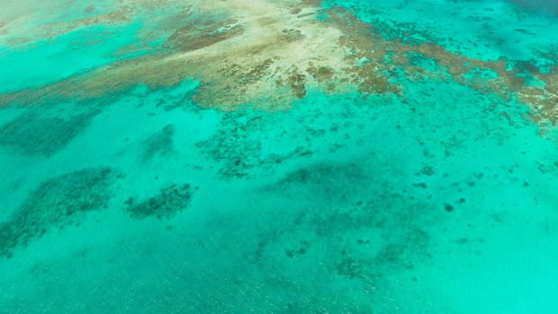 Turquoise lagoon surface on atoll and coral reef, copy space for text. Top view transparent turquoise ocean water surface. background texture