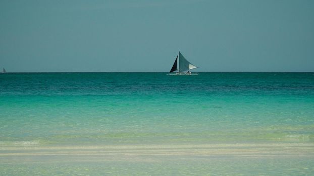 Sailing yacht in lagoon turquoise water, aerial view. Sailing boat glides over the waves, Summer and travel vacation concept