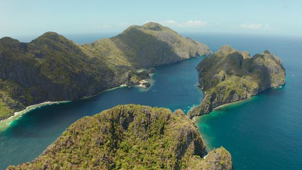 Seascape with tropical rocky islands, ocean blue water, aerial view . islands and mountains covered with tropical forest. El nido, Philippines, Palawan. Tropical Mountain Range