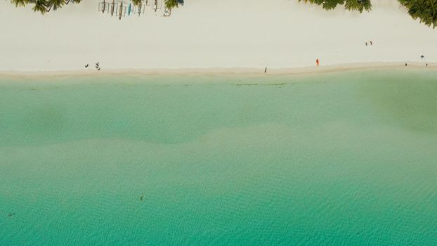 Tropical white sand beach in a lagoon with turquoise water on Boracay Island, Philippines., aerial view. Seascape with beach on tropical island. Summer and travel vacation concept.