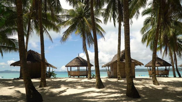 Beach with white sand with beach house on a tropical island Daco. Beautiful sky, sea, resort. Seascape: Ocean and beautiful beach paradise. Philippines. Travel concept.