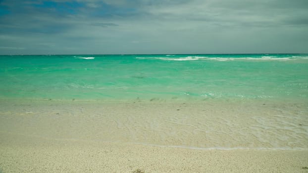 Beautiful tropical and turquoise sea with waves. Summer and travel vacation concept.