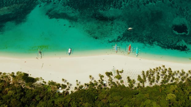 Sandy beach and turquoise water in the tropical resort of Boracay, Puka shell beach, Philippines aerial view. White beach with tourists. Summer and travel vacation concept.