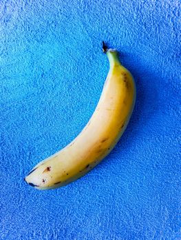 Yellow banana lie on blue towel