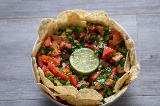 Homemade pico de gallo with a lime center piece . High quality photo