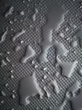 Splashes of water on shower tray highlighted in color 