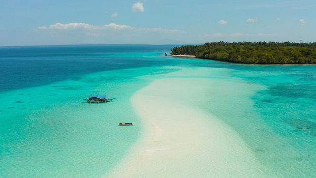 Sand bar in transparent turquoise water top view. Tropical beach with tourists. Mansalangan sandbar, Balabac, Palawan, Philippines. Summer and travel vacation concept
