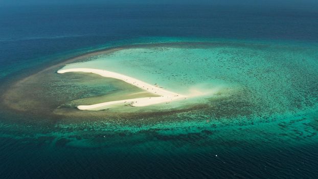 Sandy white island with beach and sandy bar in the turquoise atoll water, aerial drone. Sandbar Atoll. Tropical island and coral reef. Summer and travel vacation concept, Camiguin, Philippines.