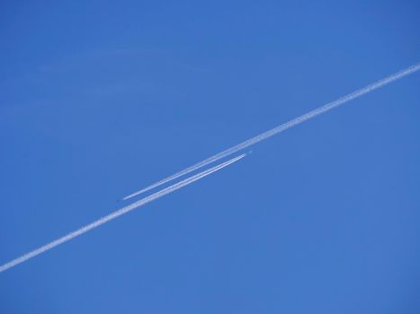 Two planes flying high in the blue sky