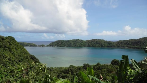Seascape tropical island, lagoon, beach and hills.. Tropical landscape sky, clouds and mountains rocks with rainforest. Blue lagoon in the ocean. Travel concept.