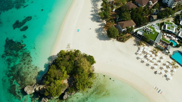 Travel concept: sandy beach and hotels near the blue lagoon, from above, Boracay, Philippines. Seascape with beach on tropical island. Summer and travel vacation concept.