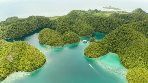 Turquoise waters of the Sugba Lagoon and islands covered with green forest and jungle. Siargao, Philippines. Summer and travel vacation concept.
