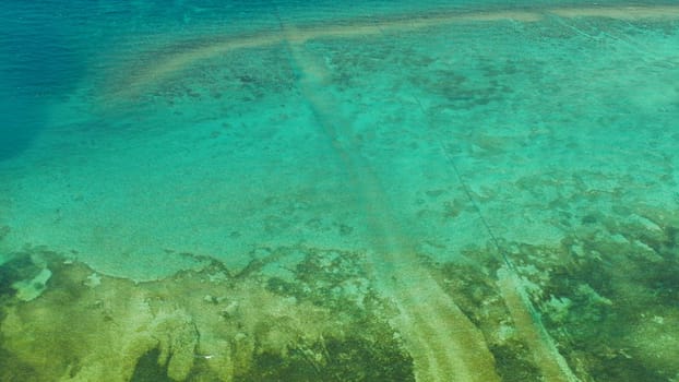 Sea water surface in lagoon, background with sun light reflection, copy space for text, aerial view. Top view transparent turquoise ocean water surface. background texture