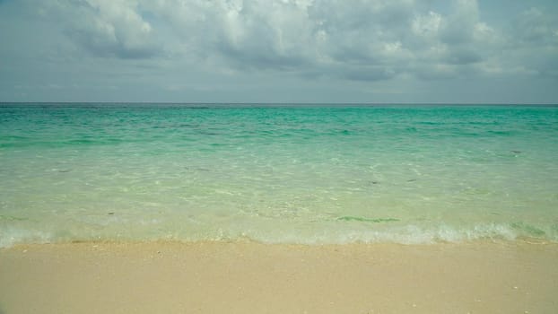 Tropical beach on a background of sky and clouds. Summer and travel vacation concept.