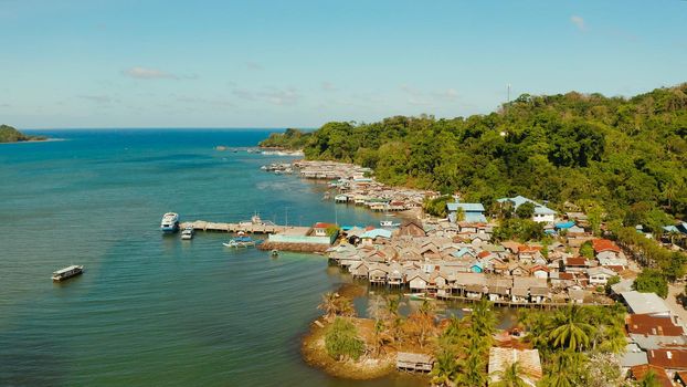 Village of stilt houses built over the sea, top view. City and port on Balabac Island, Palawan, Philippines.