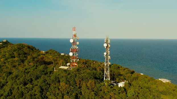 Telecommunication tower, communication antenna in tropical island aerial view. Repeaters on a metal tower. Boracay, Philippines
