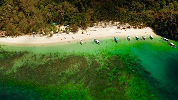 Tropical lagoon with sandy beach, aerial view. El nido, Philippines, Palawan. Seascape with tropical rocky islands, ocean blue water. Summer and travel vacation concept