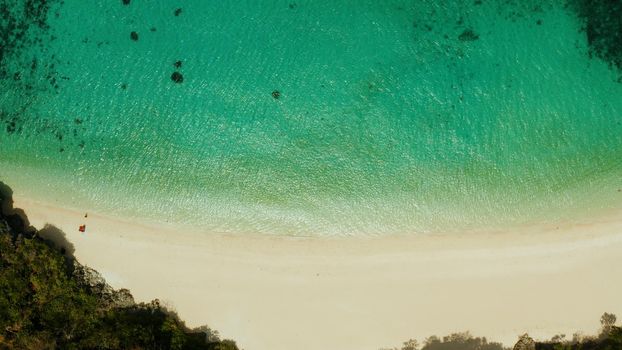 Tropical sandy beach with wave and turquoise water,copy space for text, aerial view. Ocean with waves and tropical beach. Summer and travel vacation concept